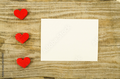 Empty card with heart on wooden table