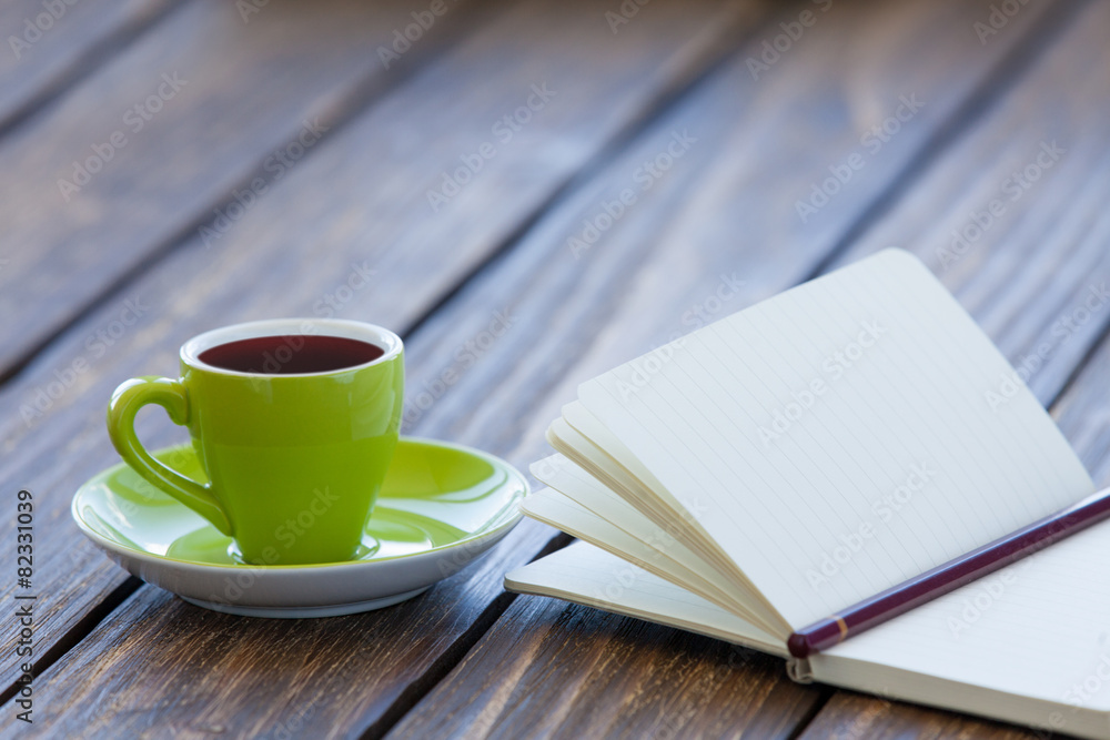 Cup of coffee and notebook with pencil Cup of coffee and notebook with pencil