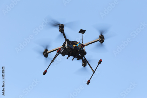 Fototapeta Naklejka Na Ścianę i Meble -  Professional drone octocopter flying on blue sky