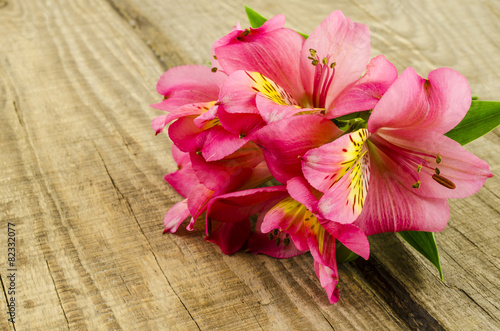 Pink flowers bouquet on wooden table