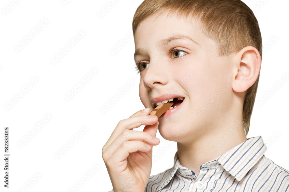 Portrait of a boy biting milk chocolate bar Portrait of a boy biting milk chocolate bar