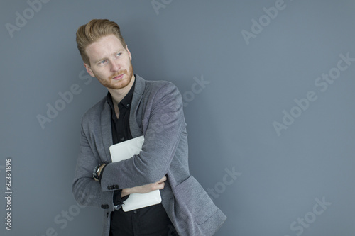 Man with tablet by the wall