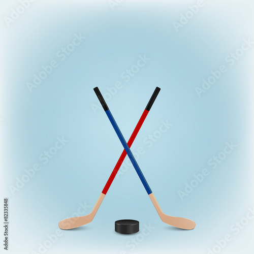 Two crossed hockey sticks and puck. Vector EPS10 background.