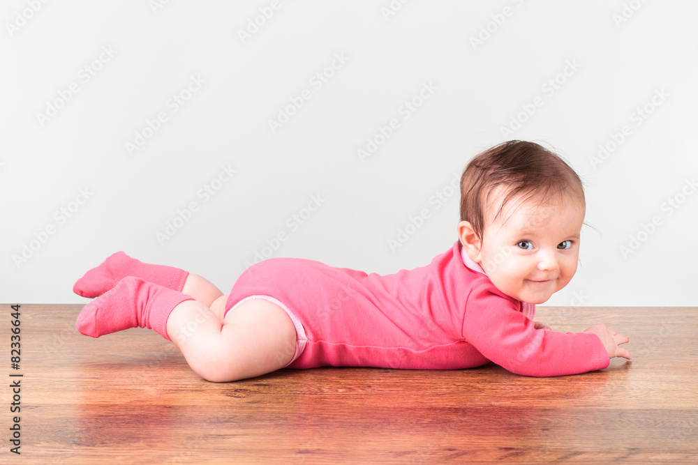 Smiling little baby girl playing on the floor Smiling little baby girl playing on the floor
