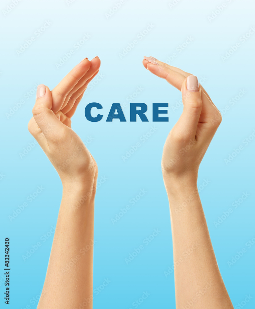 Female hands with word care on blue background Female hands with word care on blue background