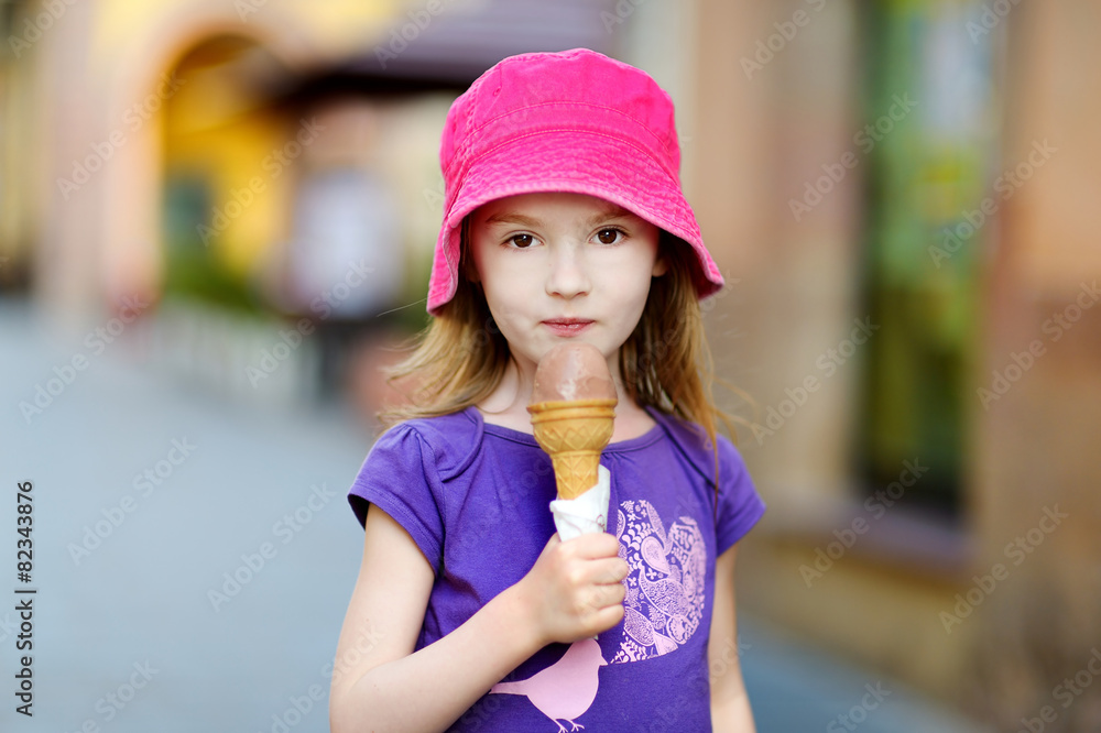Adorable little girl eating ice-cream outdoors Adorable little girl eating ice-cream outdoors