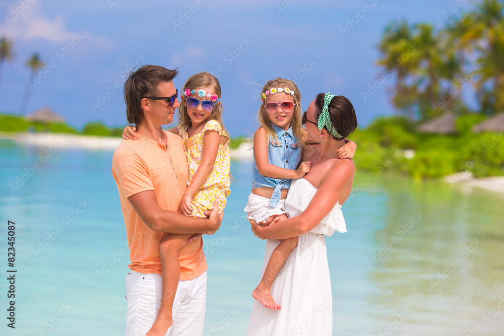 Happy beautiful family on white beach during summer vacation Happy beautiful family on white beach during summer vacation