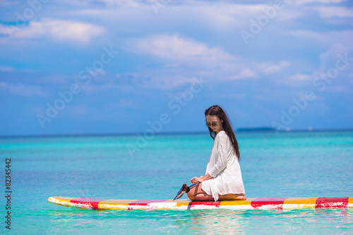 Active young woman on stand up paddle board © travnikovstudio