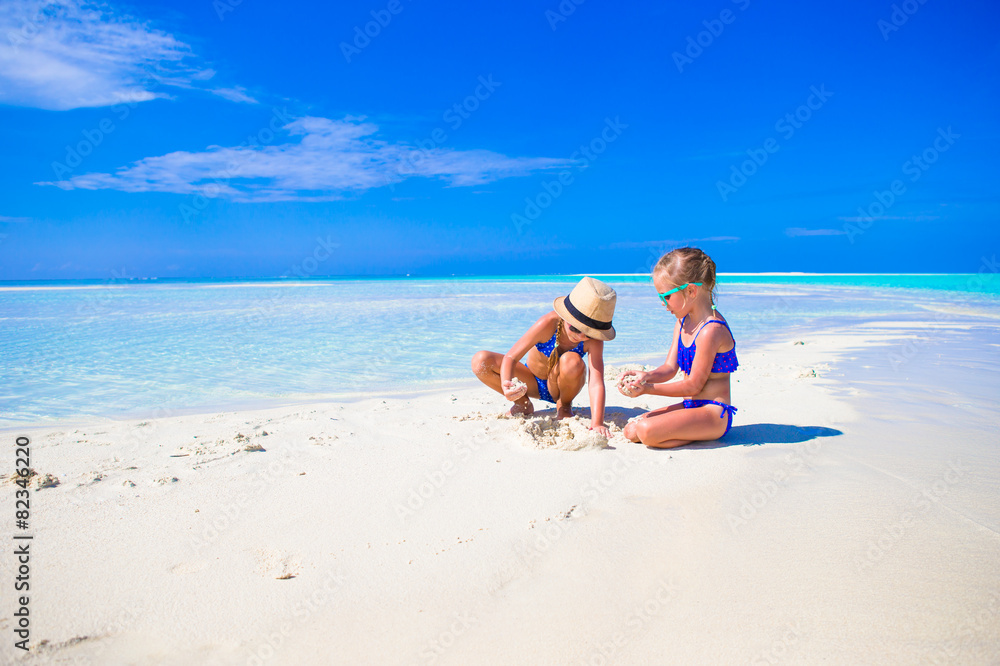 Adorable little girls on beach during summer vacation Adorable little girls on beach during summer vacation