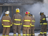 Firefighter in front of smoking house