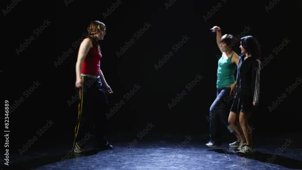 WS Studio shot of three young women dancing WS Studio shot of three young women dancing