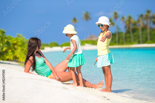 Young mother and two her little girls at exotic beach on sunny
