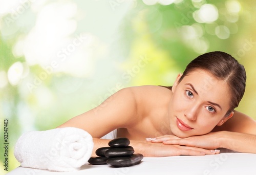 Spa. Relaxed young female getting a stone massage in a spa