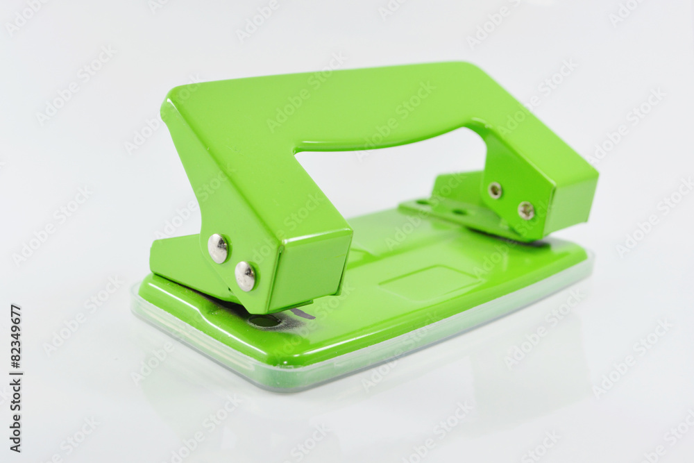 Green hole puncher isolated on white background.
