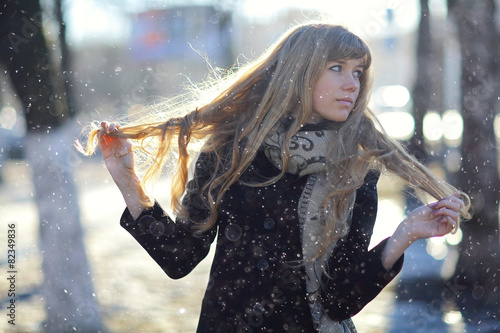 portrait of a girl with long blond hair outside in the spring photo