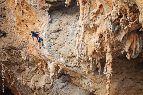 Rock climber on overhanging cliff 