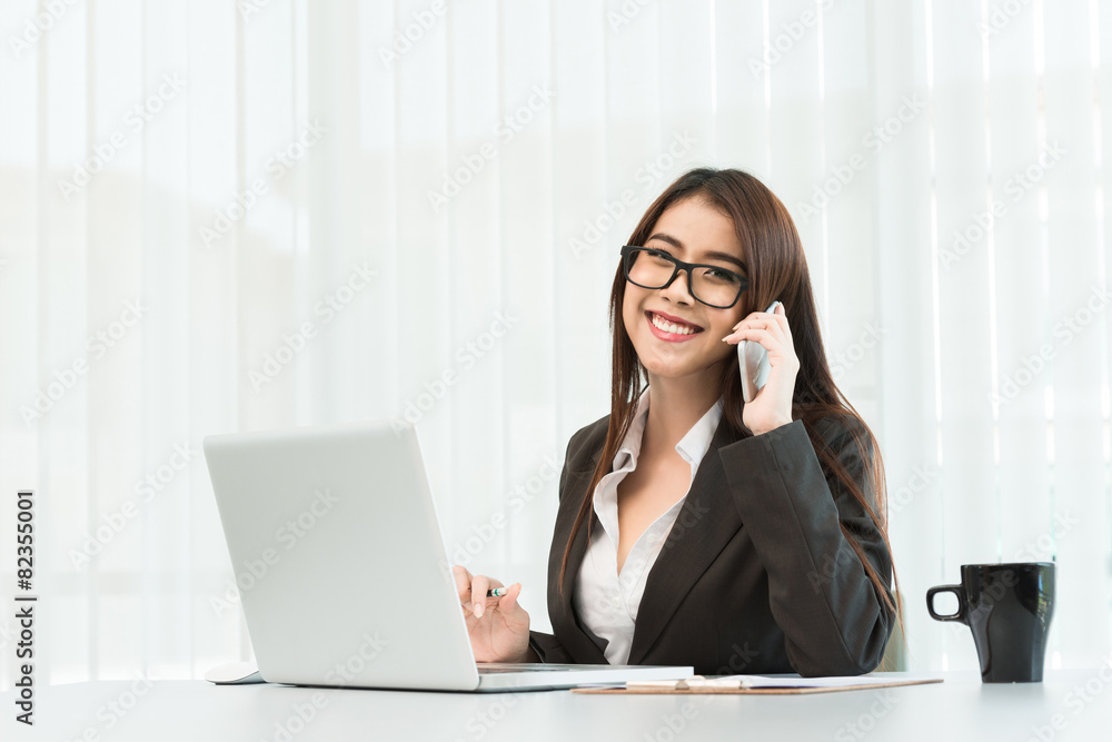 Portrait of a young business woman using laptop at office Portrait of a young business woman using laptop at office