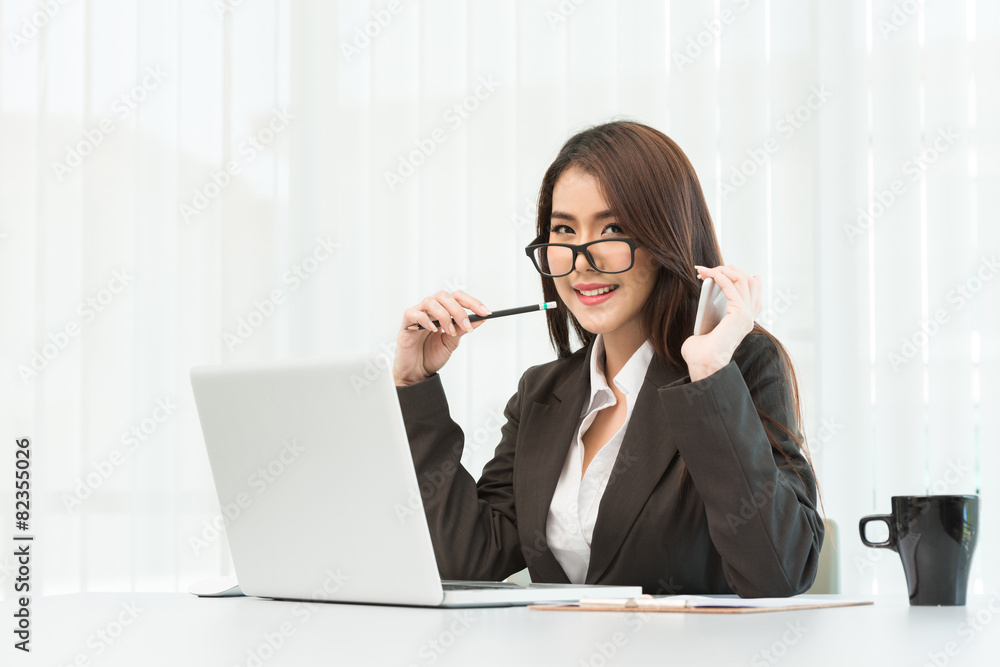 Portrait of a young business woman using laptop at office Portrait of a young business woman using laptop at office
