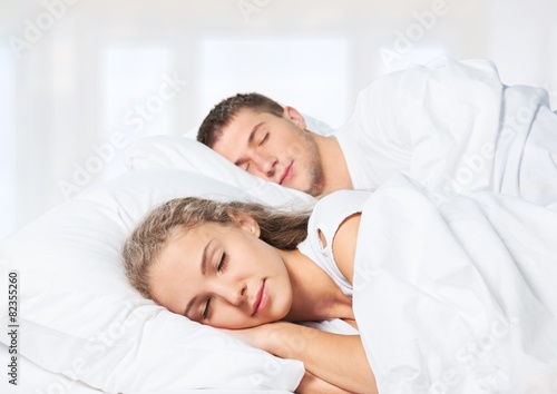 Adult. Romantic young couple sleeping in bed