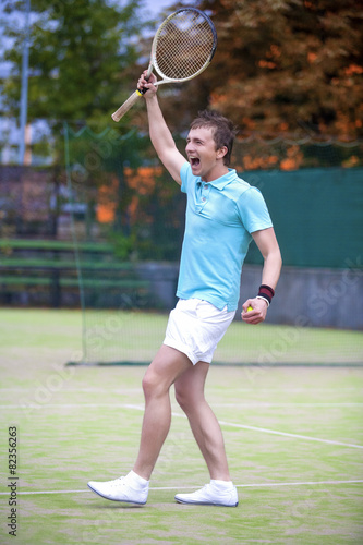 Tennis Sport Concept: Portrait of young Exclaiming Male Caucasia © danmorgan12