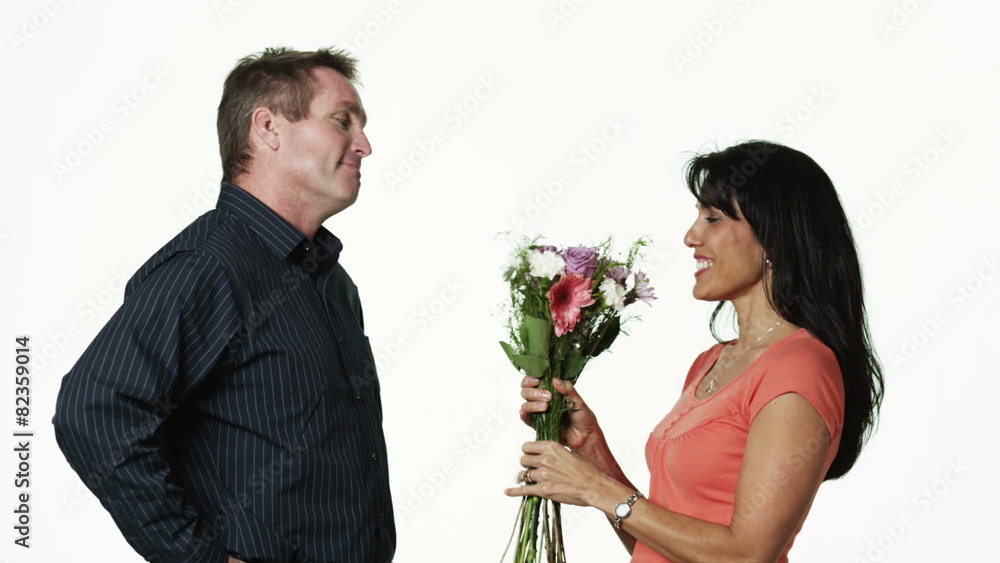MS Man giving flowers to woman, against white background / Orem, Utah, USA MS Man giving flowers to woman, against white background / Orem, Utah, USA