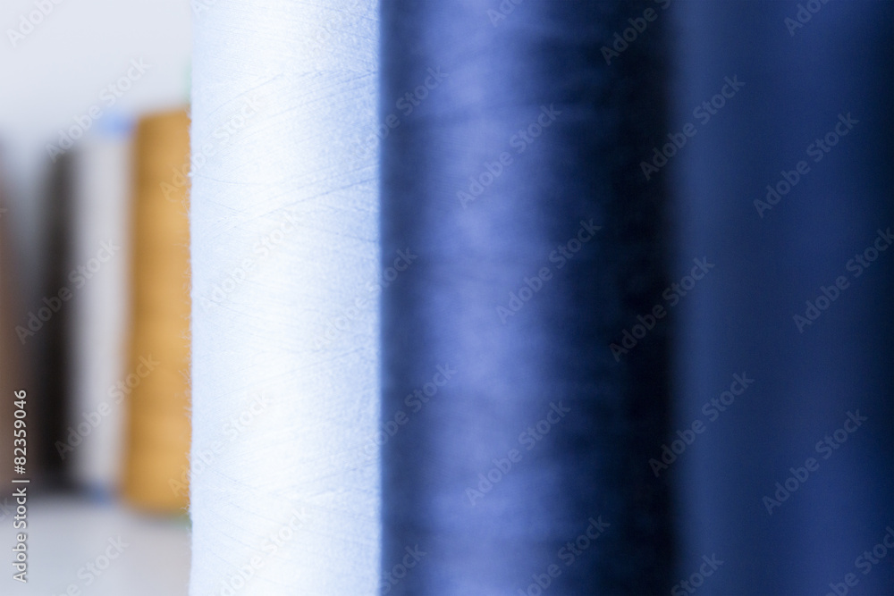 colored bobbins thread background. colored bobbins thread background.