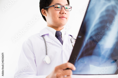 close up of male doctor holding x-ray or roentgen image