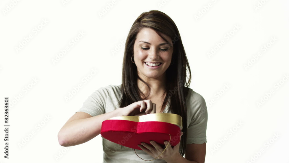 MS Portrait of young woman eating candy against white background / Orem, Utah, USA MS Portrait of young woman eating candy against white background / Orem, Utah, USA