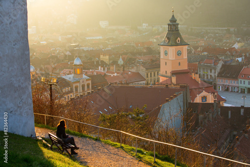 Woman admiring th old Brasov city buildings roof, The Council Ho photo