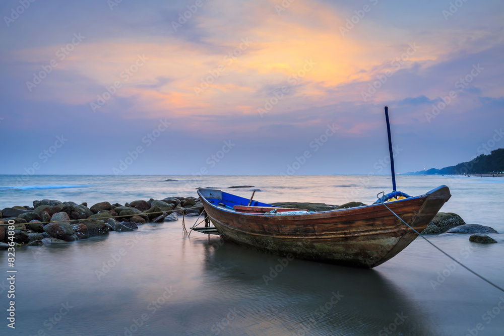 boat on beach in sunset