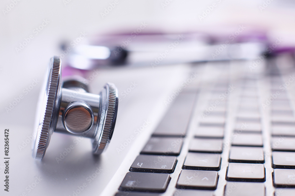 Violet stethoscope on a laptop computer Violet stethoscope on a laptop computer