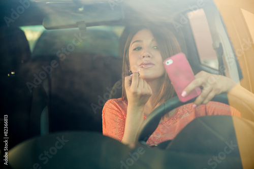 Konstfotografi Reckless woman getting distracted while driving a car