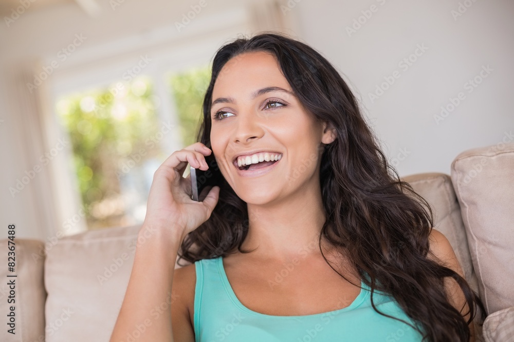 Pretty brunette calling with her mobile phone Pretty brunette calling with her mobile phone