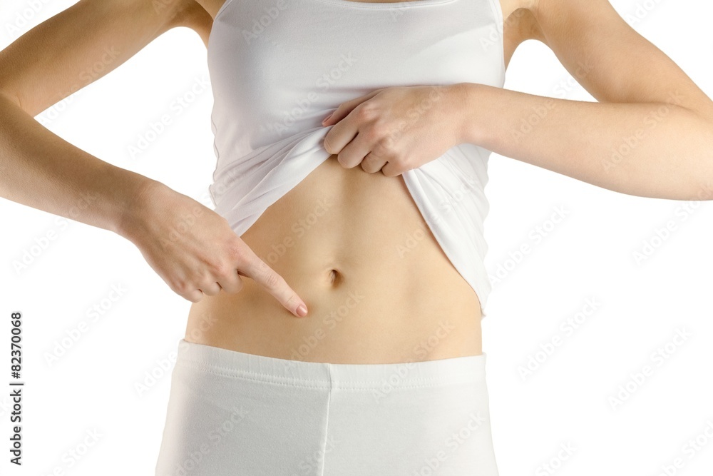 Slim woman touching her belly Slim woman touching her belly