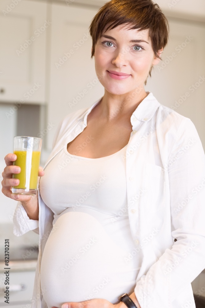 Pregnant woman having a glass of orange juice Pregnant woman having a glass of orange juice