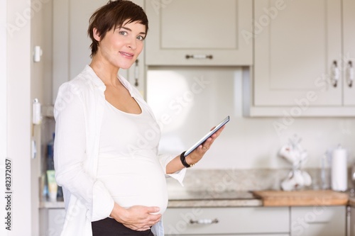 Pregnant woman using tablet pc