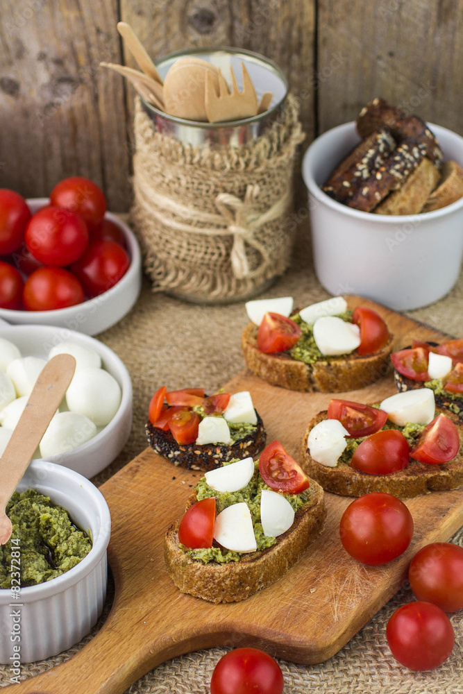 Bruschetta with fresh tomatoes, mozzarella and herb pesto Bruschetta with fresh tomatoes, mozzarella and herb pesto