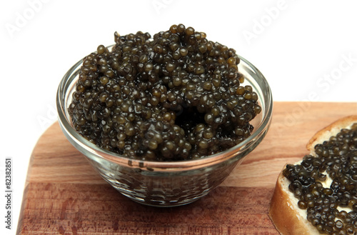 Black and red caviar in glass container photo