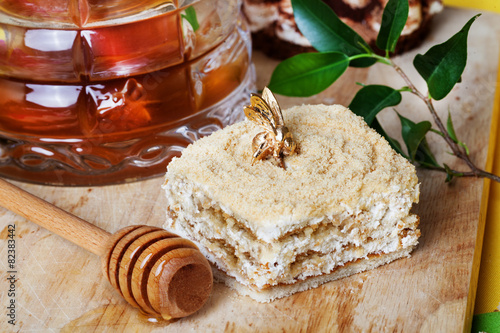 honey cake and a special spoon in still life with golden bee