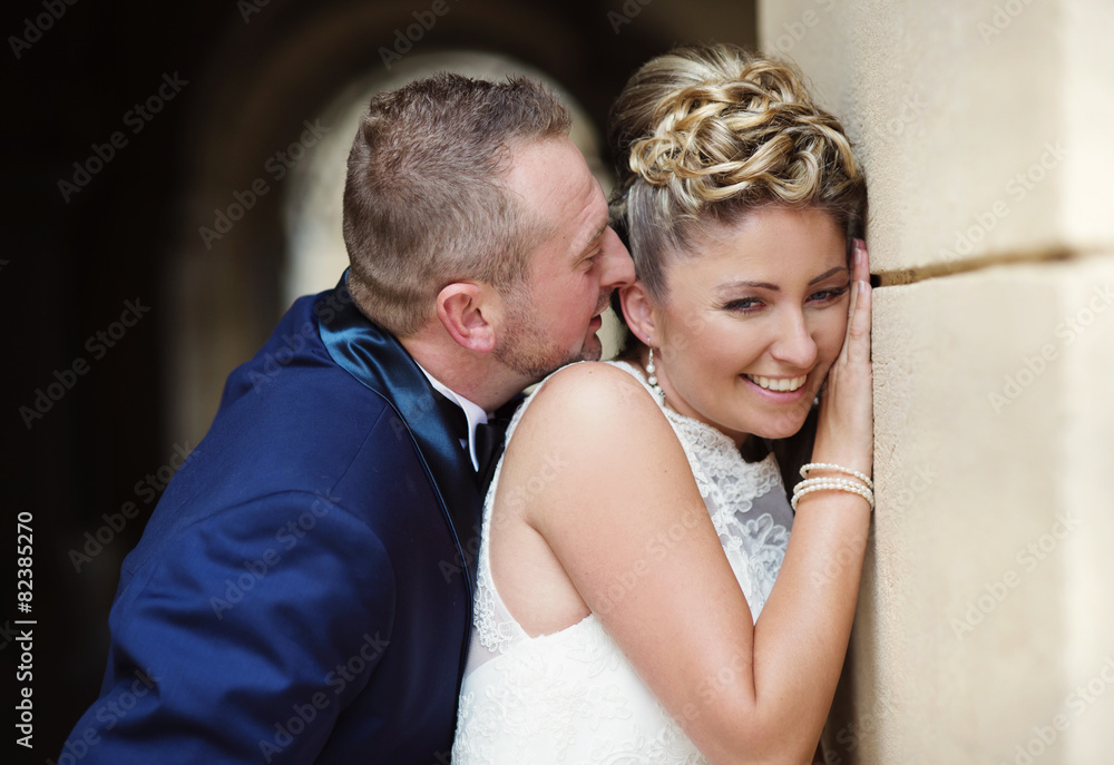 Wedding couple enjoying romantic moments in front of a castle Wedding couple enjoying romantic moments in front of a castle