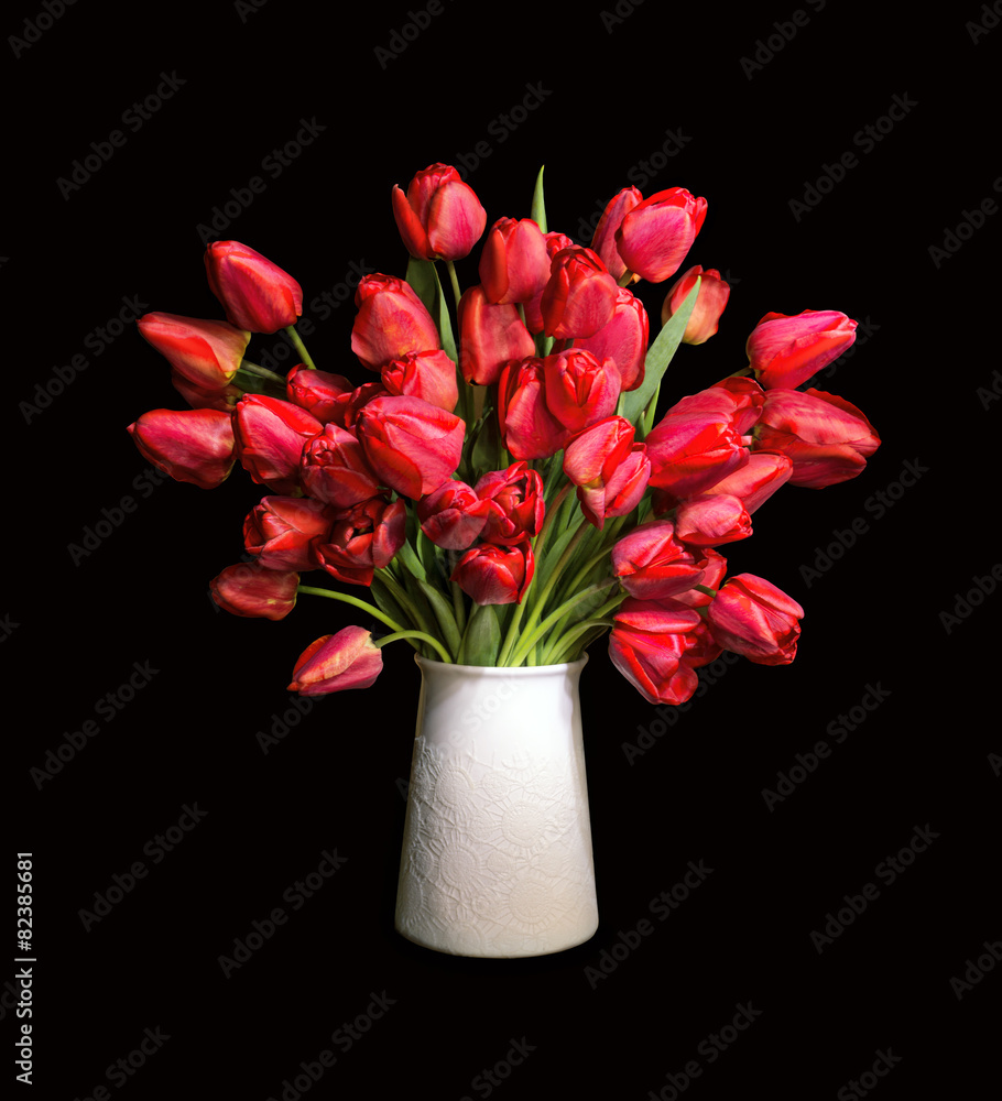 Bouquet of red tulips in white vase