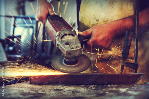 Man Grinding in workshop,shallow depth of filed