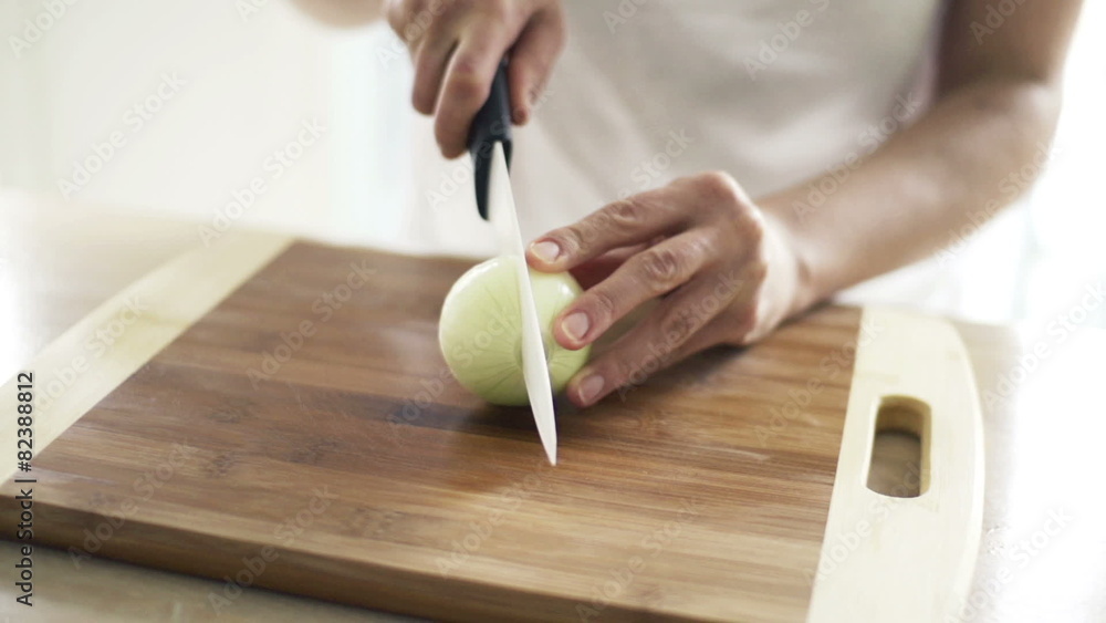 Woman slicing onion in kitchen, slow motion shot at 240fps
Woman slicing onion in kitchen, slow motion shot at 240fps