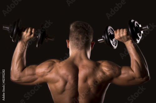 muscle bodybuilder man from behind lifting weights
