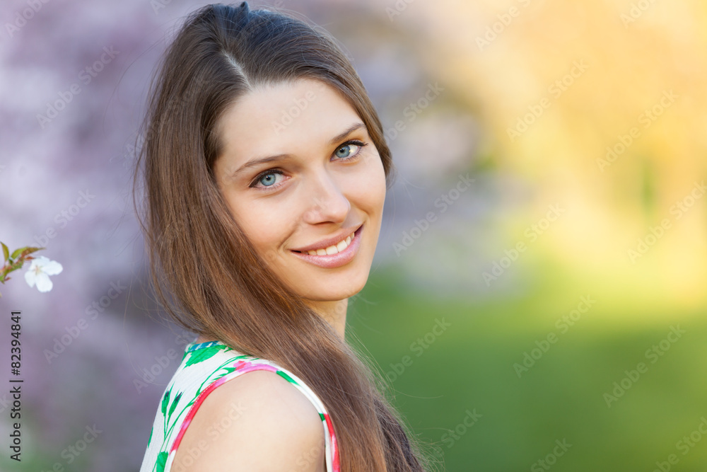 Beautiful brunette woman in blooming orchard Beautiful brunette woman in blooming orchard