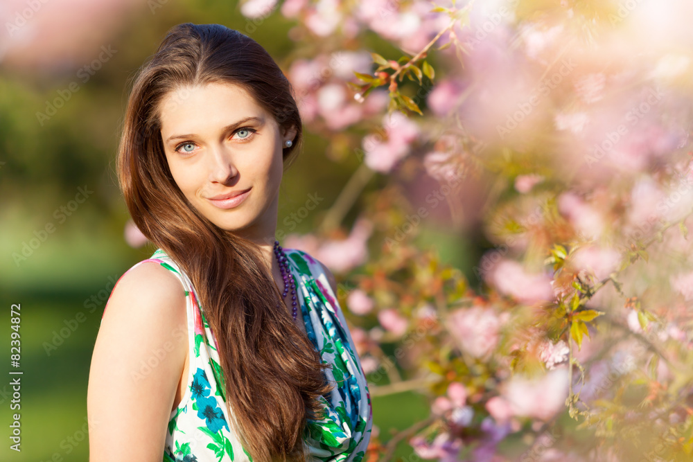 Beautiful brunette woman in blooming orchard Beautiful brunette woman in blooming orchard
