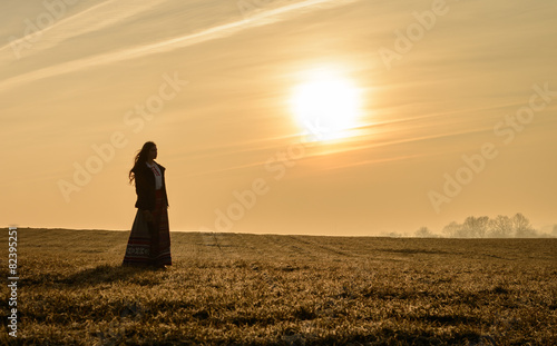 young woman in Slavic Belarusian national original suit outdoors