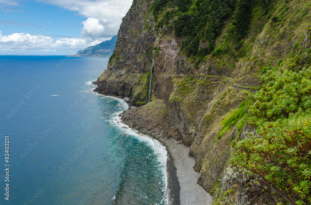 Steep northern shore of the island of Madeira, a waterfall.