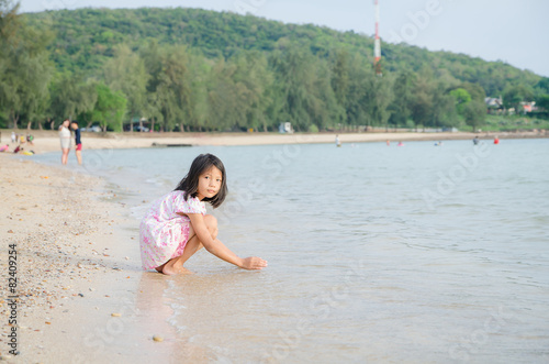 Asian kids Thai girl playing on the beach - Summer vacation