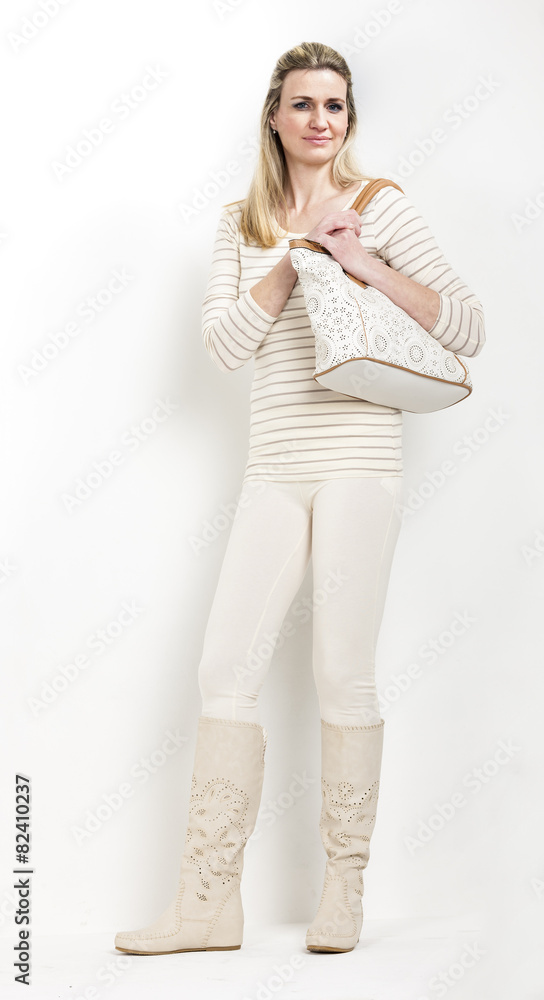 standing woman wearing summer boots with a handbag standing woman wearing summer boots with a handbag